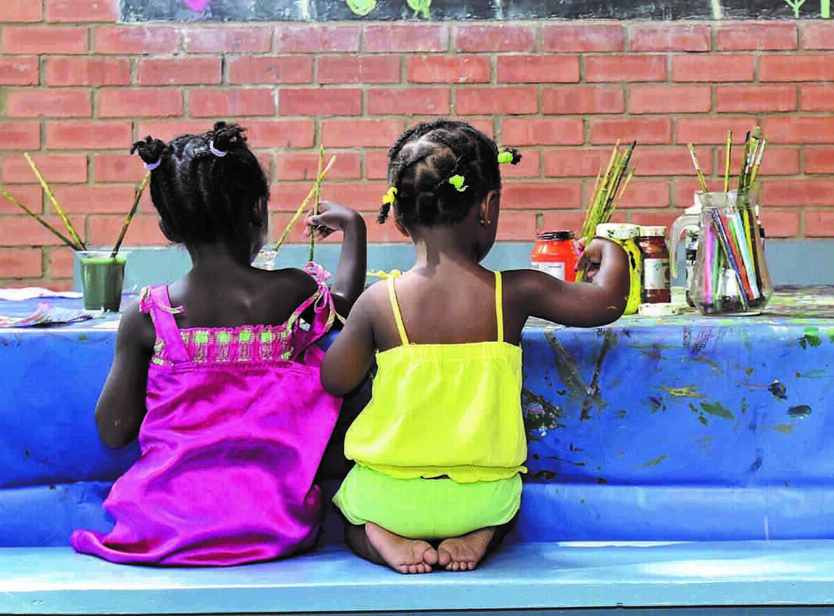 backs of little girls painting