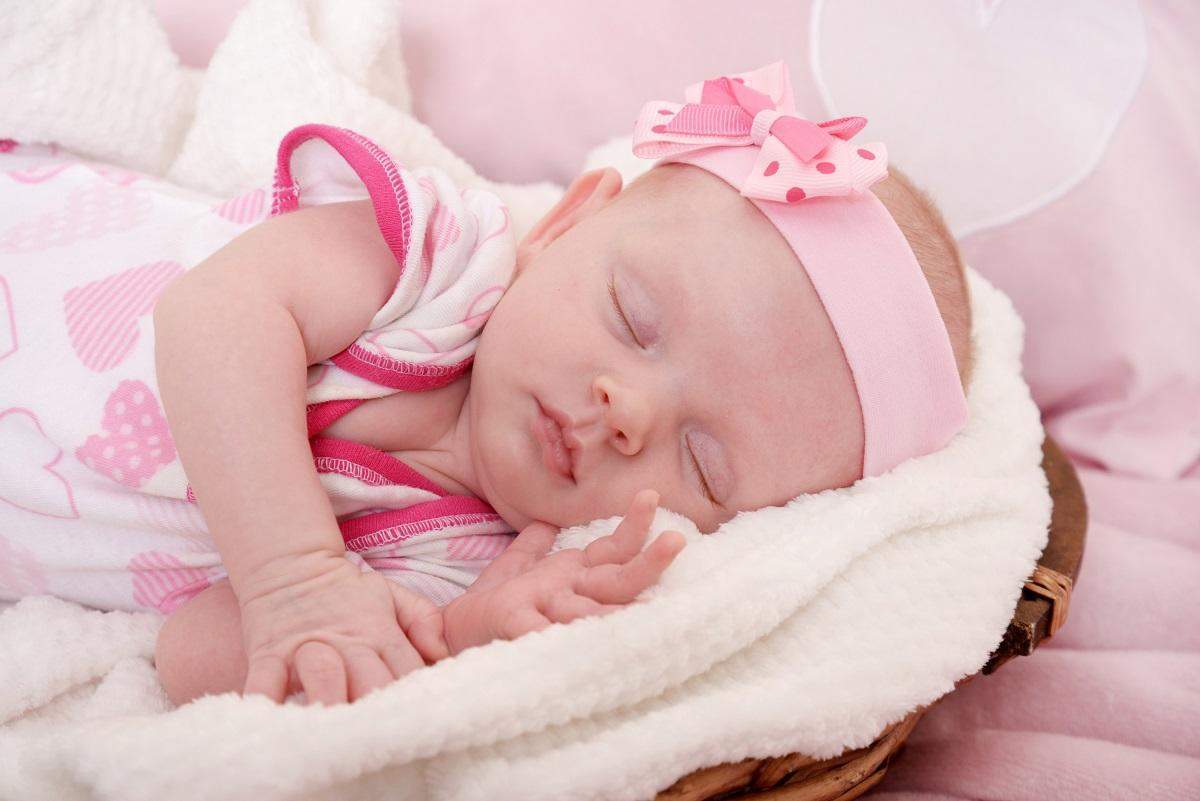 baby girl sleeping in pink