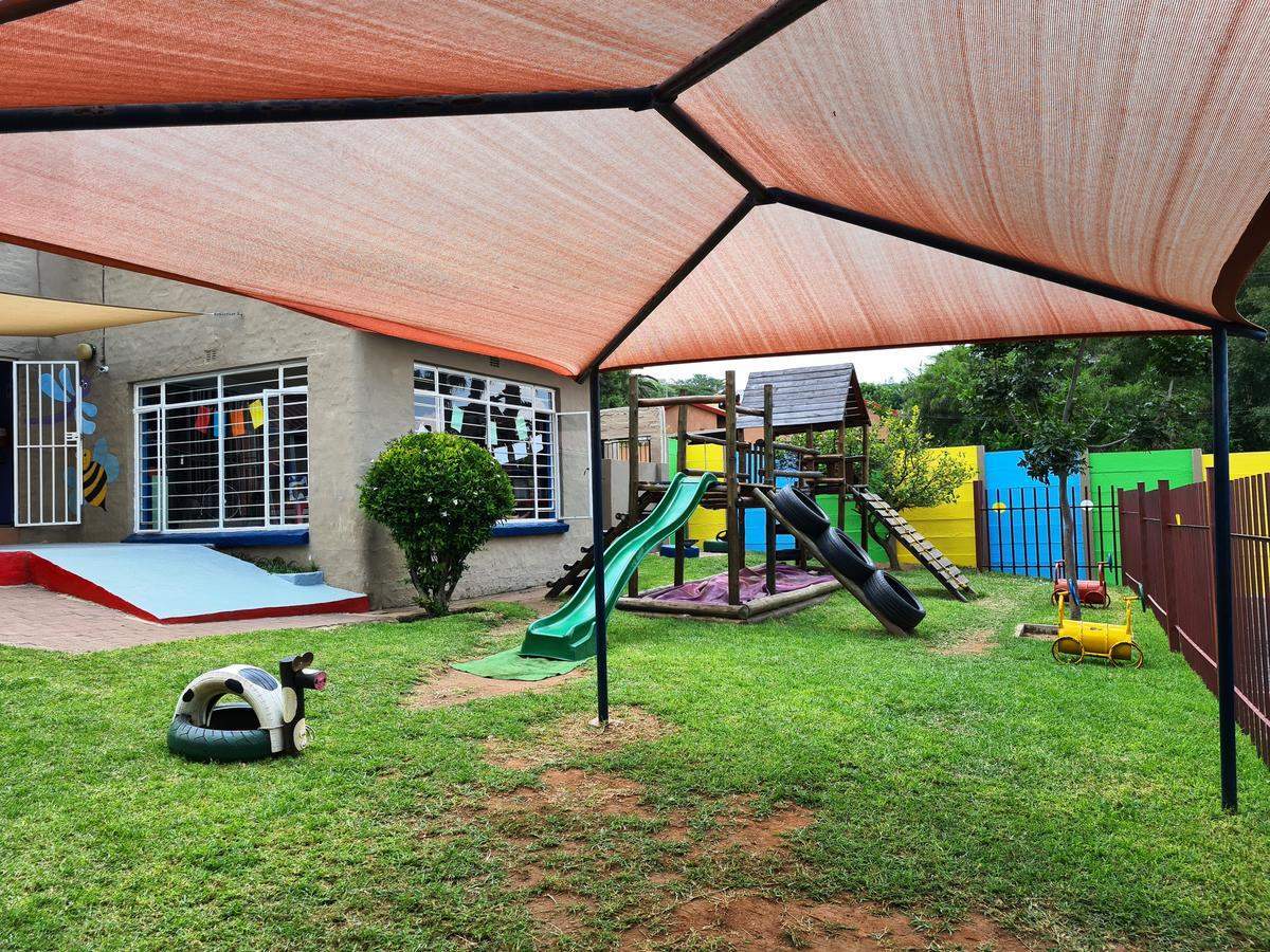 preschool jungle gym with green slide