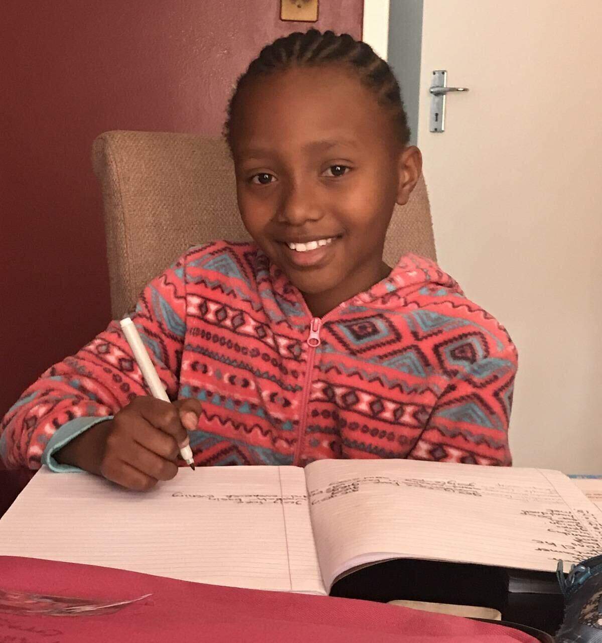 boy smiling and studying