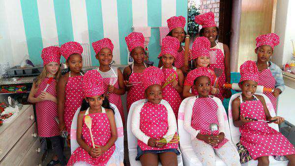 kids in pink dots aprons and chef hats