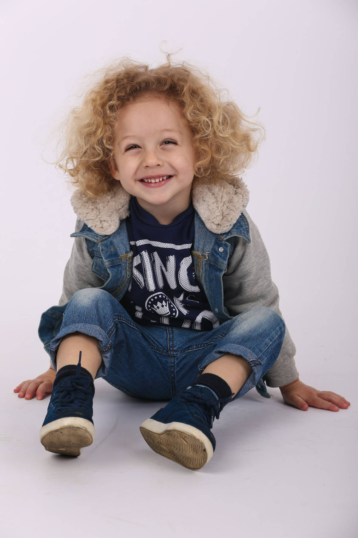 boy with curly hair and denim jacket