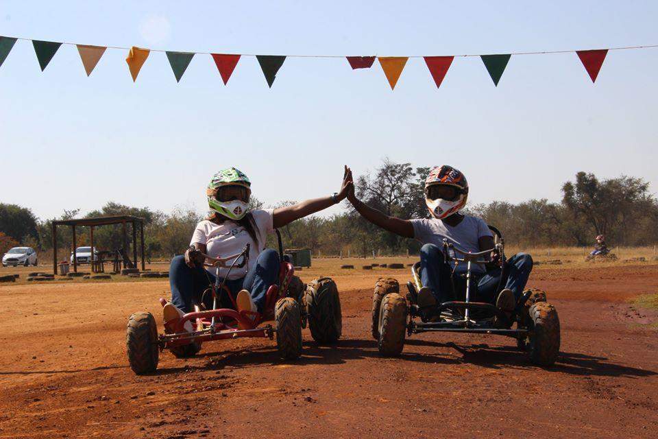 2 go-karters touching hands